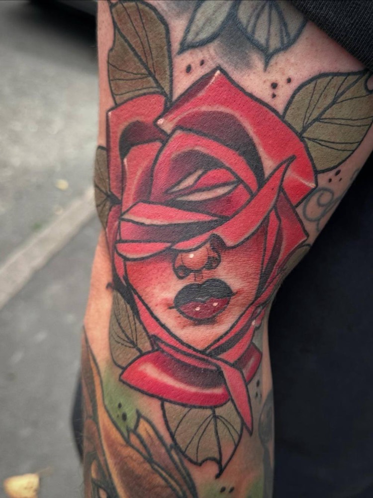 Woman's face inside a red rose
