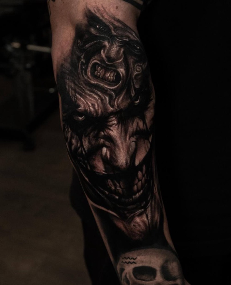 Demon face on a forearm