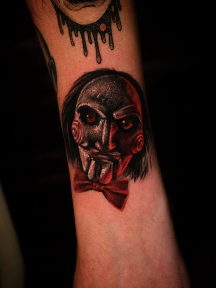 Jigsaw puppet with a red bow tie